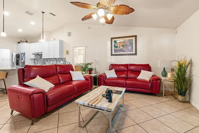 a living room with furniture and a chandelier