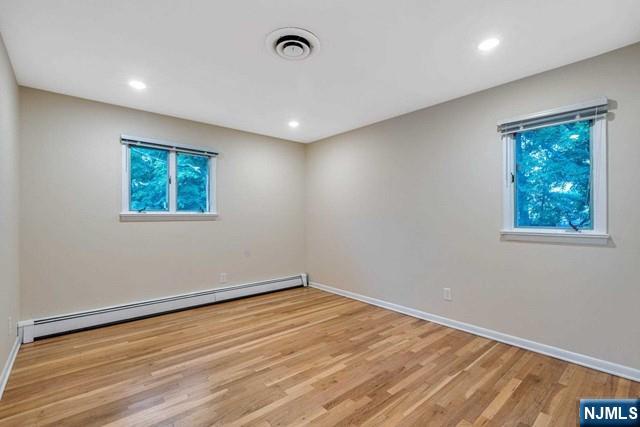 32 Rock Road Englewood Cliffs, NJ 07632 - Photo 19 of 30 a view of empty room with wooden floor and fan