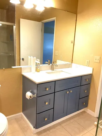 a bathroom with a sink vanity and mirror