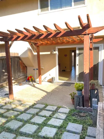 a view of a chair and tables in the patio