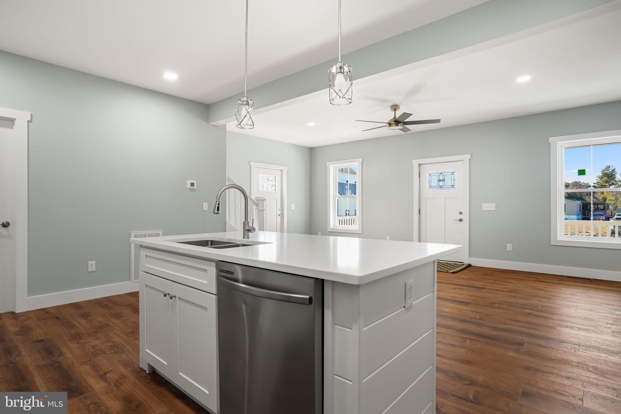 7921 East Side Road Chincoteague Island, VA 23336 - Photo 12 of 38 a kitchen with a sink and chandelier