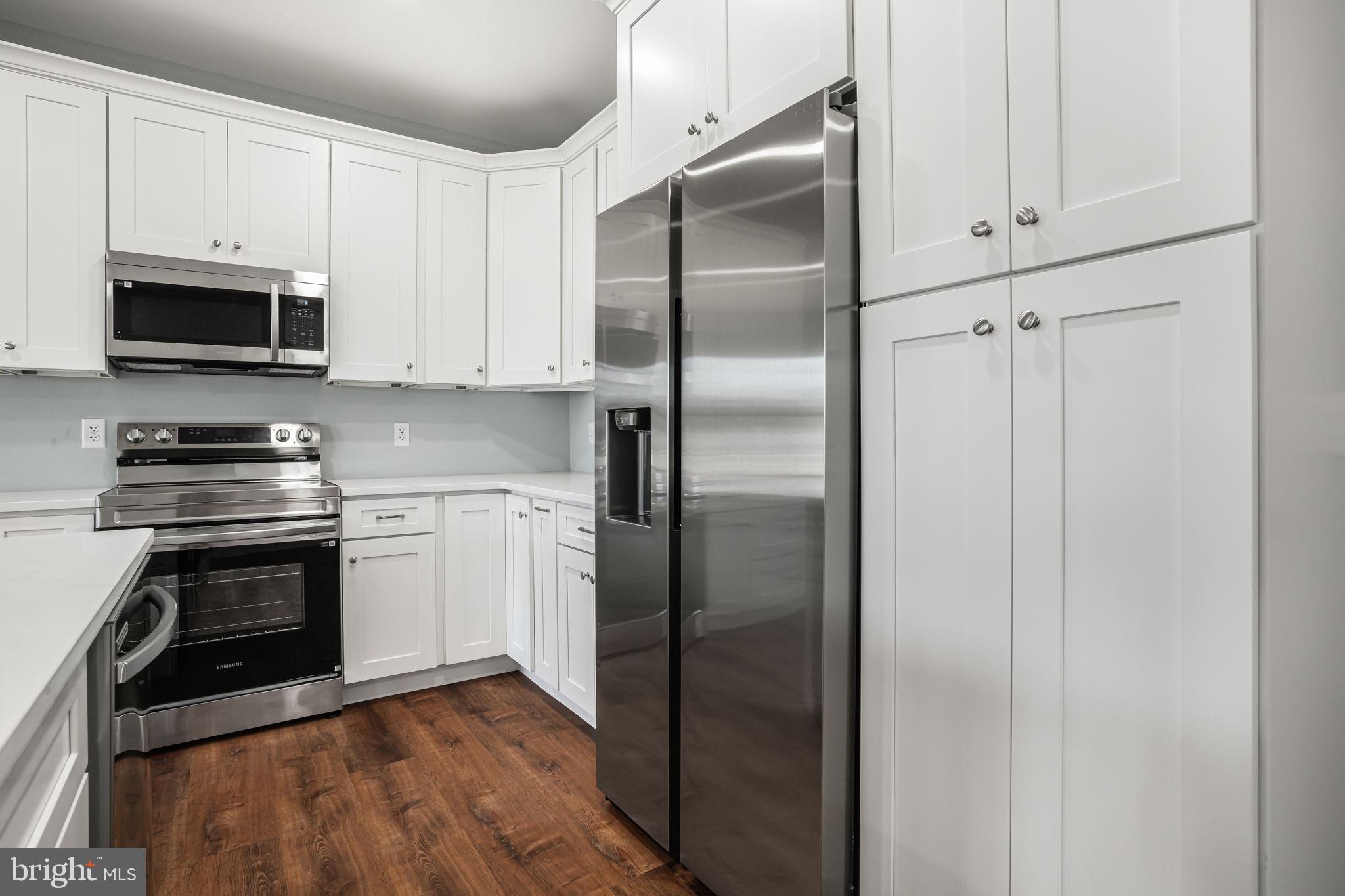 7921 East Side Road Chincoteague Island, VA 23336 - Photo 14 of 38 a kitchen with a refrigerator stove and microwave