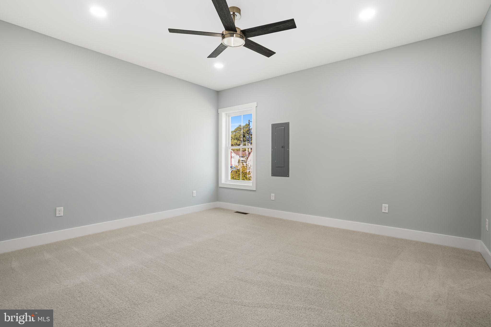 7921 East Side Road Chincoteague Island, VA 23336 - Photo 15 of 38 an empty room with windows and fan