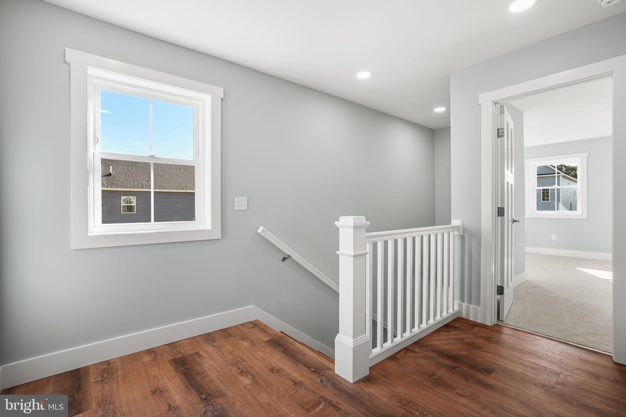 7921 East Side Road Chincoteague Island, VA 23336 - Photo 20 of 38 a view of a room with wooden floor and windows