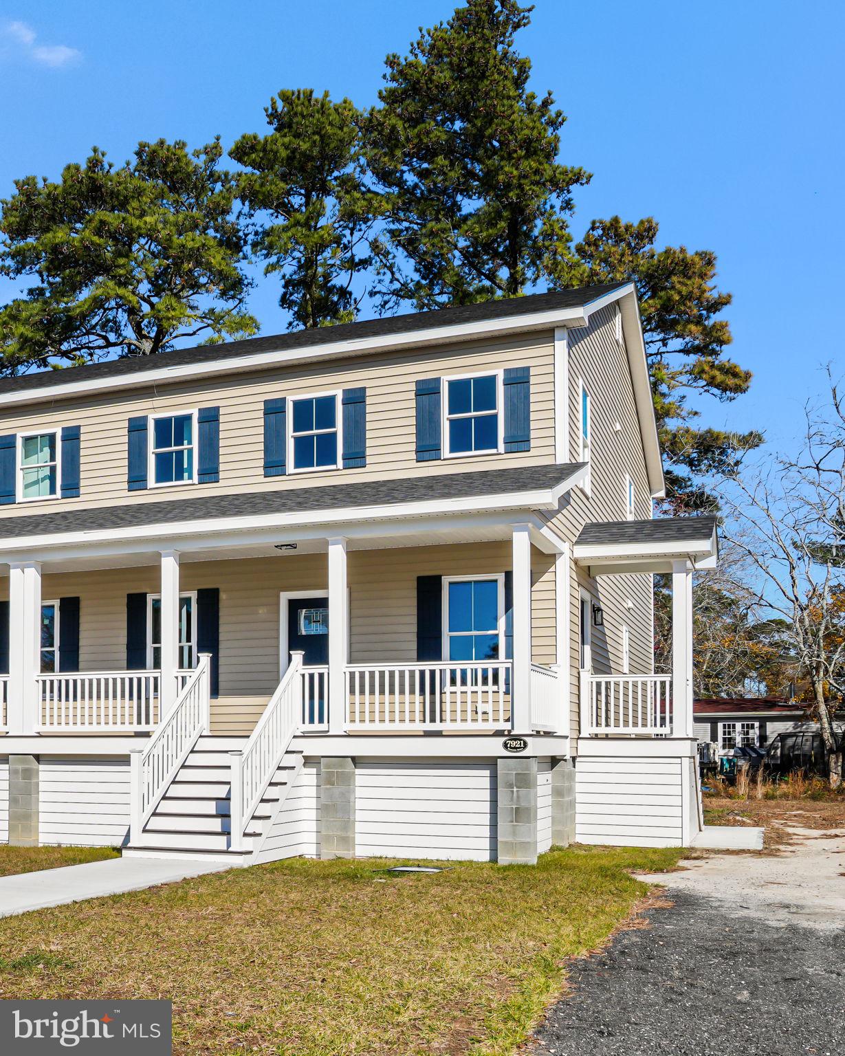 7921 East Side Road Chincoteague Island, VA 23336 - Photo 2 of 38 a front view of a house with a garden