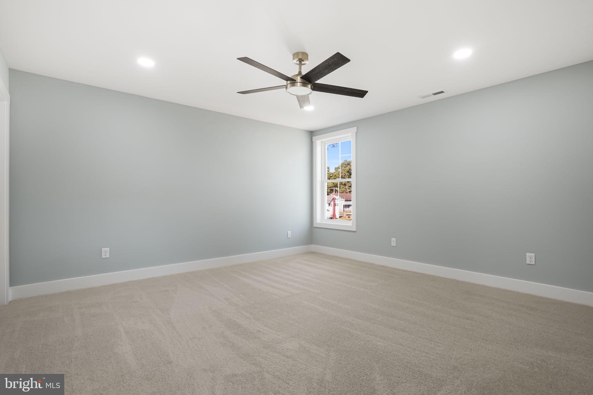 7921 East Side Road Chincoteague Island, VA 23336 - Photo 21 of 38 an empty room with a window and a fan