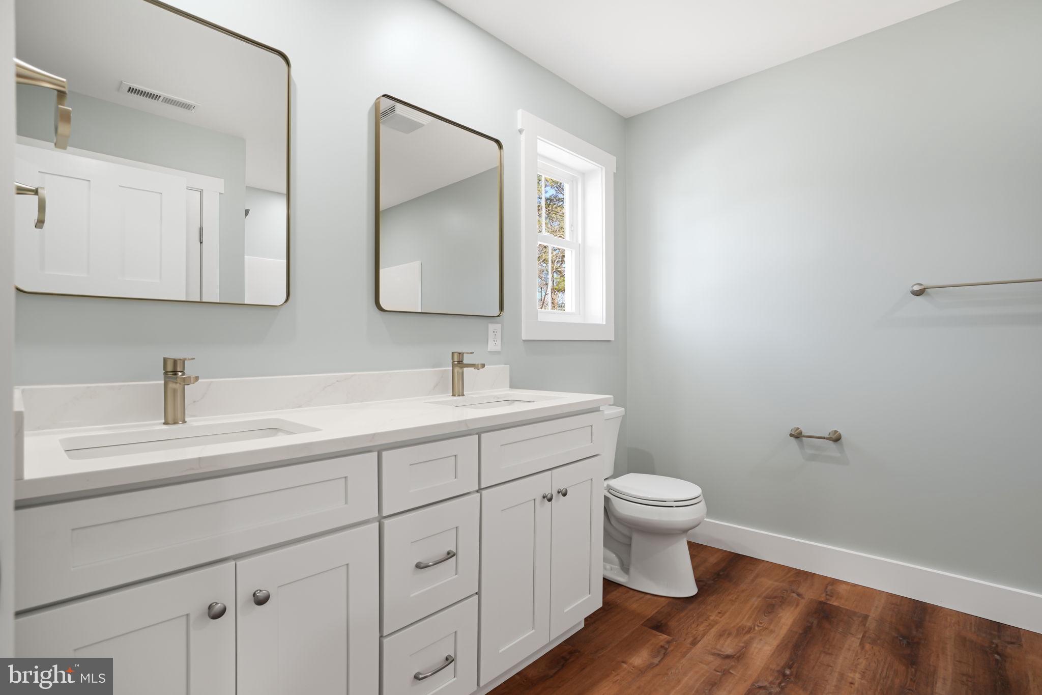 7921 East Side Road Chincoteague Island, VA 23336 - Photo 24 of 38 a bathroom with a toilet sink and mirror