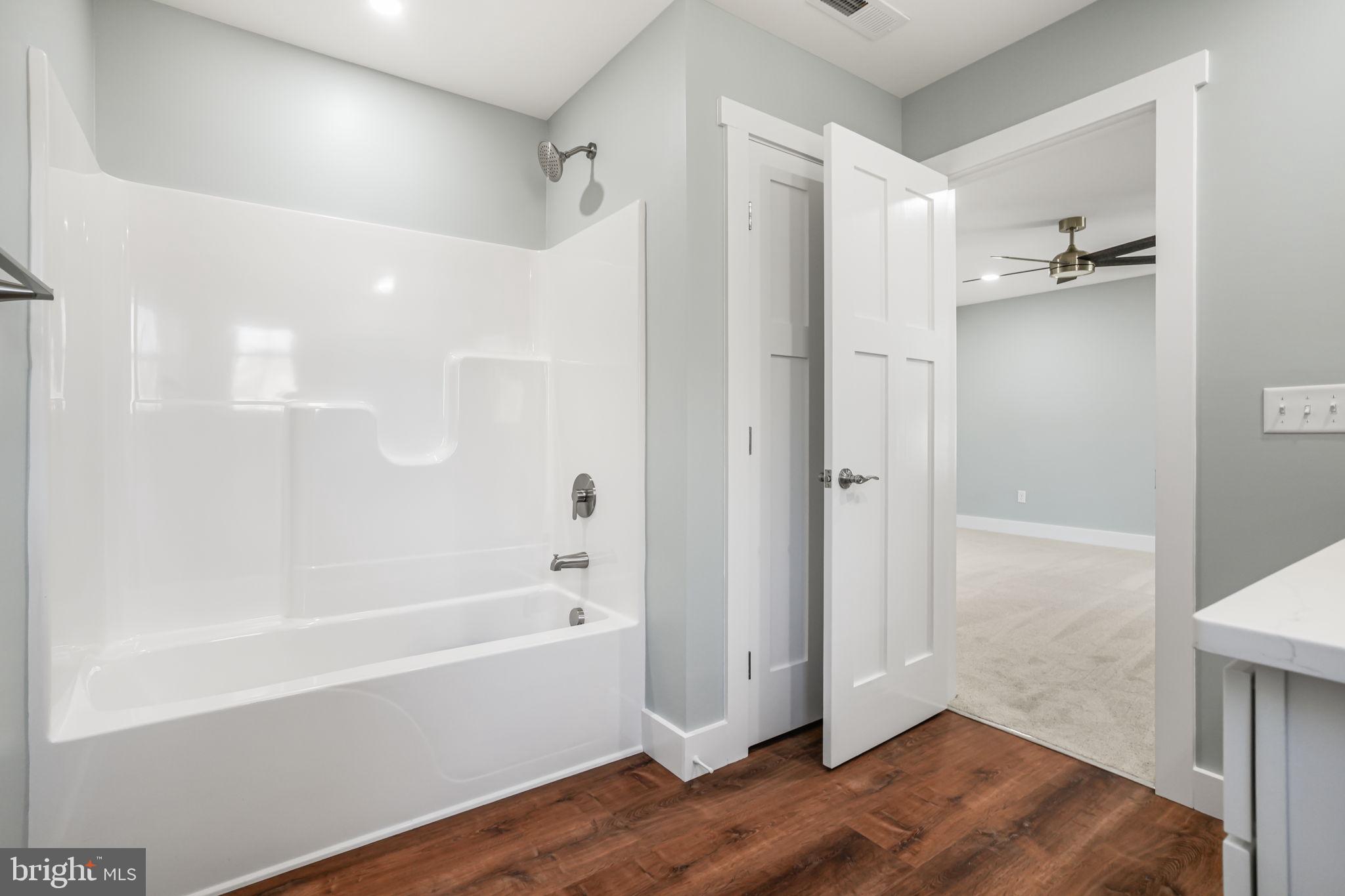 7921 East Side Road Chincoteague Island, VA 23336 - Photo 25 of 38 a bathroom with a bathtub and shower
