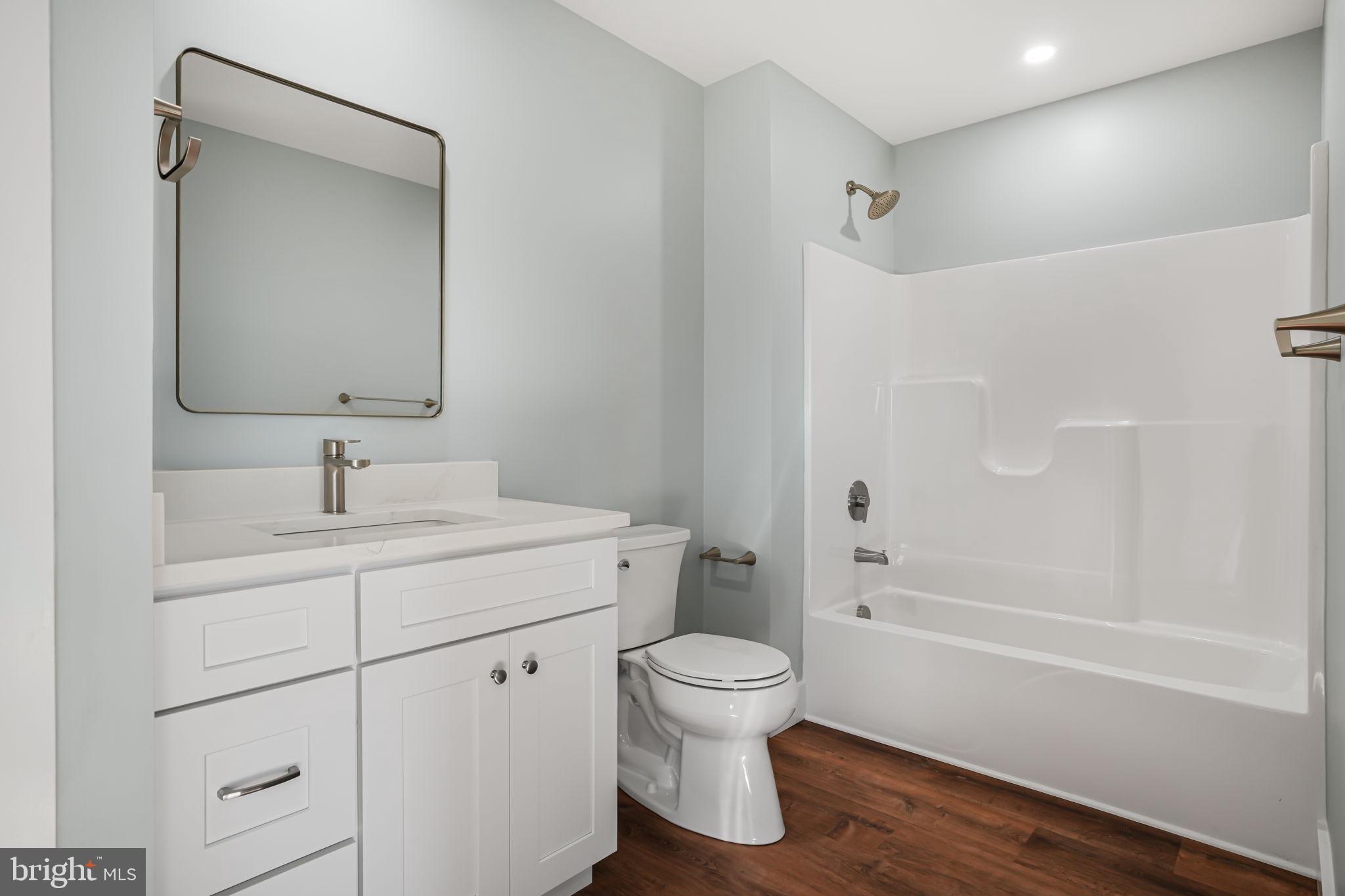 7921 East Side Road Chincoteague Island, VA 23336 - Photo 29 of 38 a bathroom with a sink toilet and shower