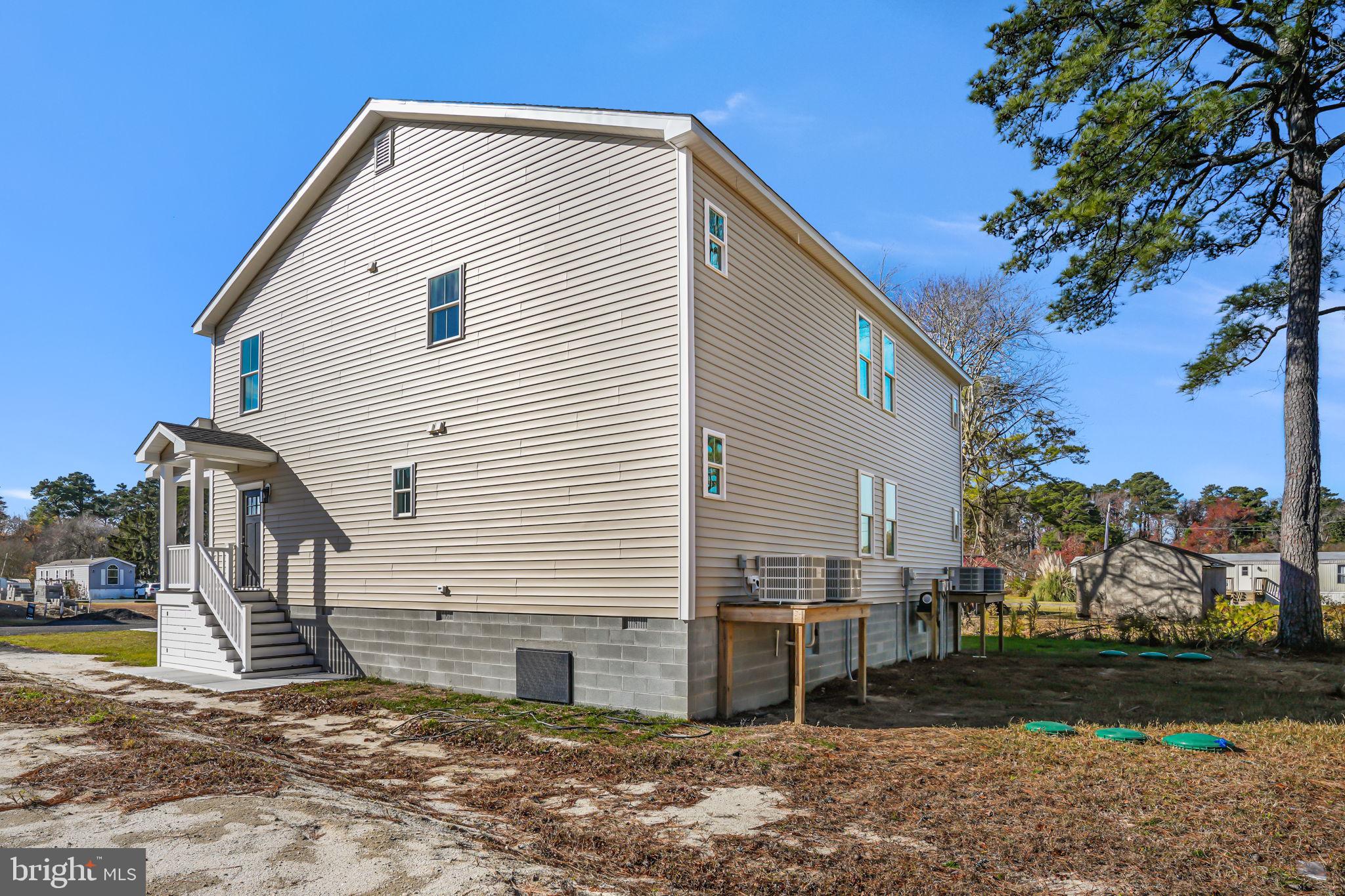 7921 East Side Road Chincoteague Island, VA 23336 - Photo 31 of 38 a view of a house with backyard and sitting area
