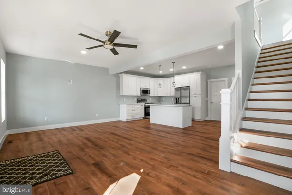 a view of kitchen with sink and wooden floor