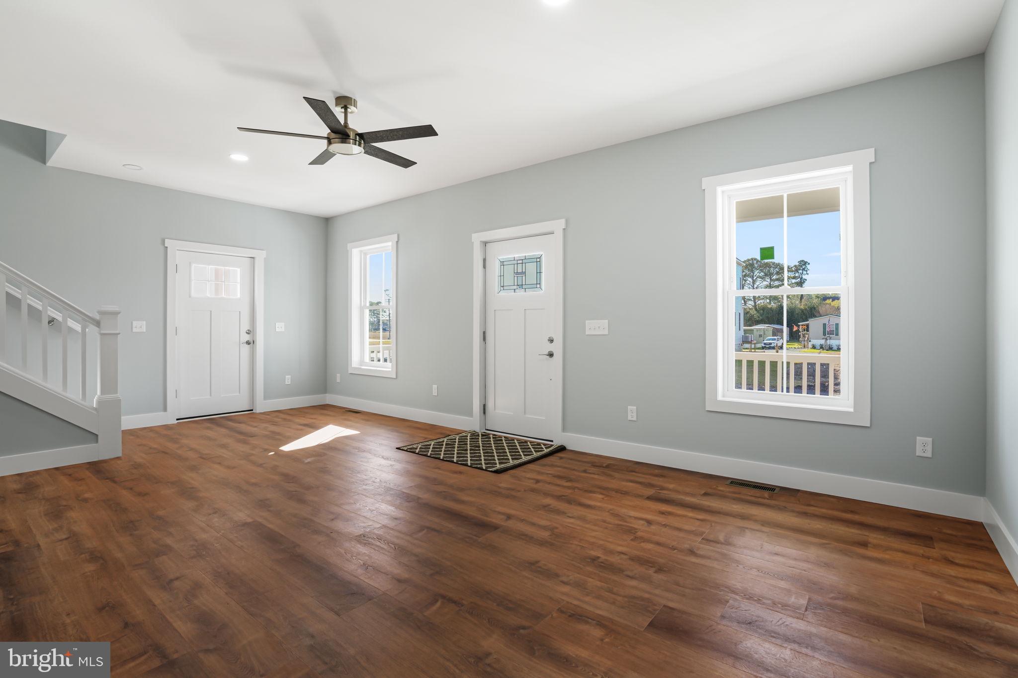 7921 East Side Road Chincoteague Island, VA 23336 - Photo 7 of 38 a view of an empty room with wooden floor and a window
