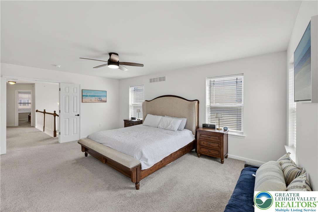 3973 Mink Road Emmaus, PA 18049 - Photo 27 of 45 a bedroom with a bed and a chandelier