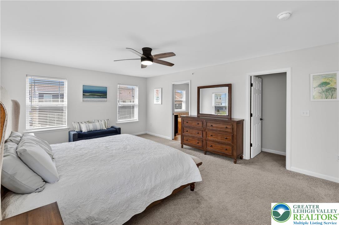 3973 Mink Road Emmaus, PA 18049 - Photo 29 of 45 a spacious bedroom with a bed a dresser and a window