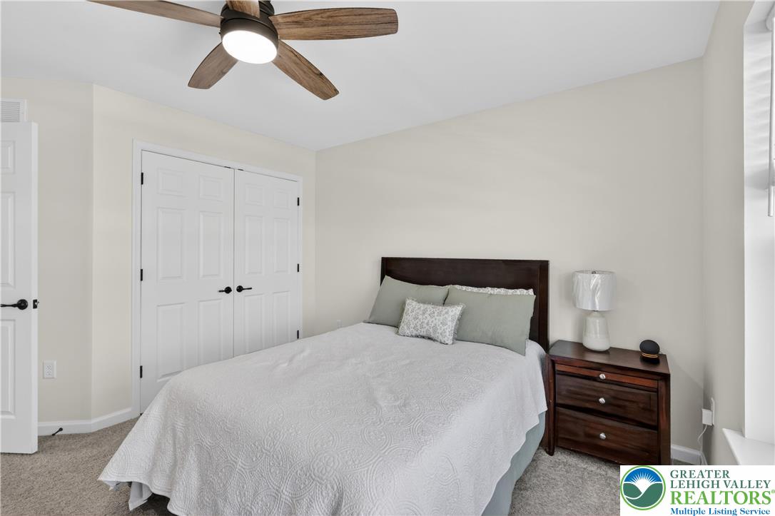 3973 Mink Road Emmaus, PA 18049 - Photo 34 of 45 a bedroom with a bed and a chandelier