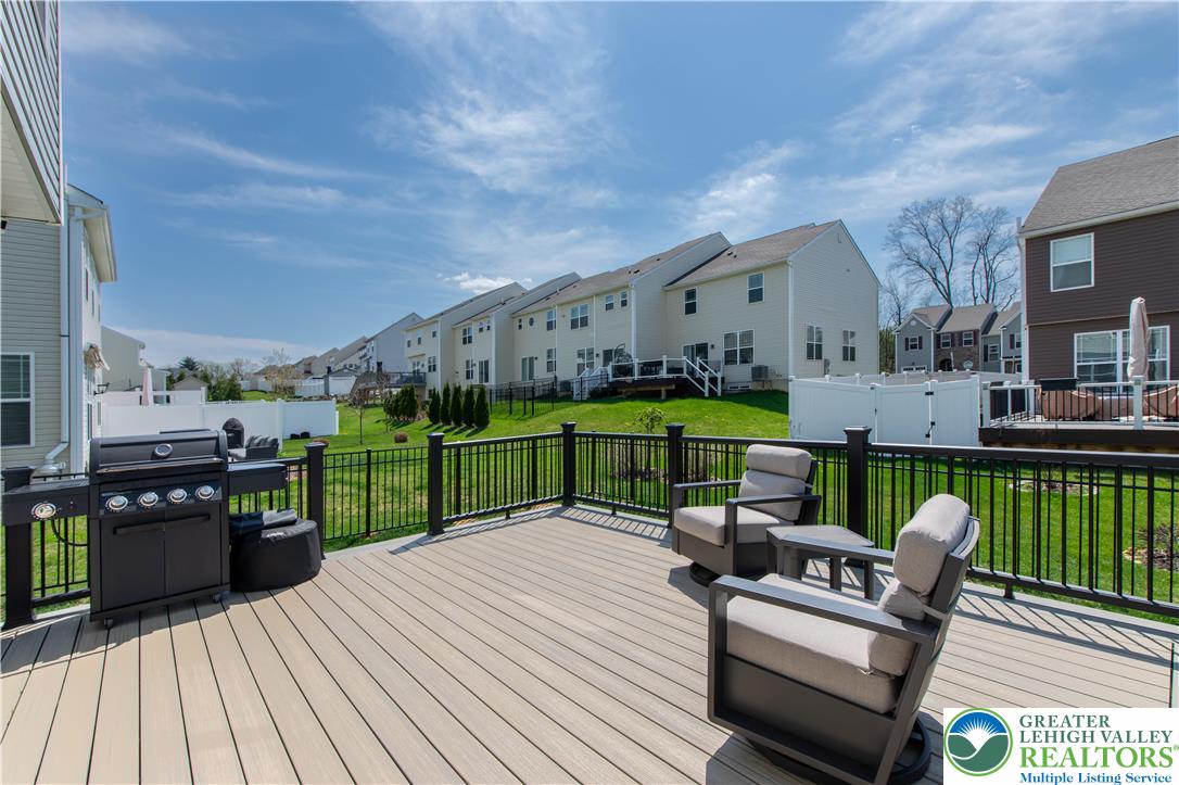 3973 Mink Road Emmaus, PA 18049 - Photo 7 of 45 a view of a chairs and table on the wooden deck