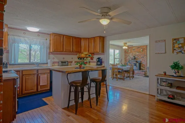 a kitchen with a table chairs refrigerator and cabinets