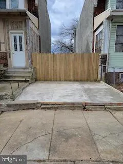 a view of a house with a wooden fence