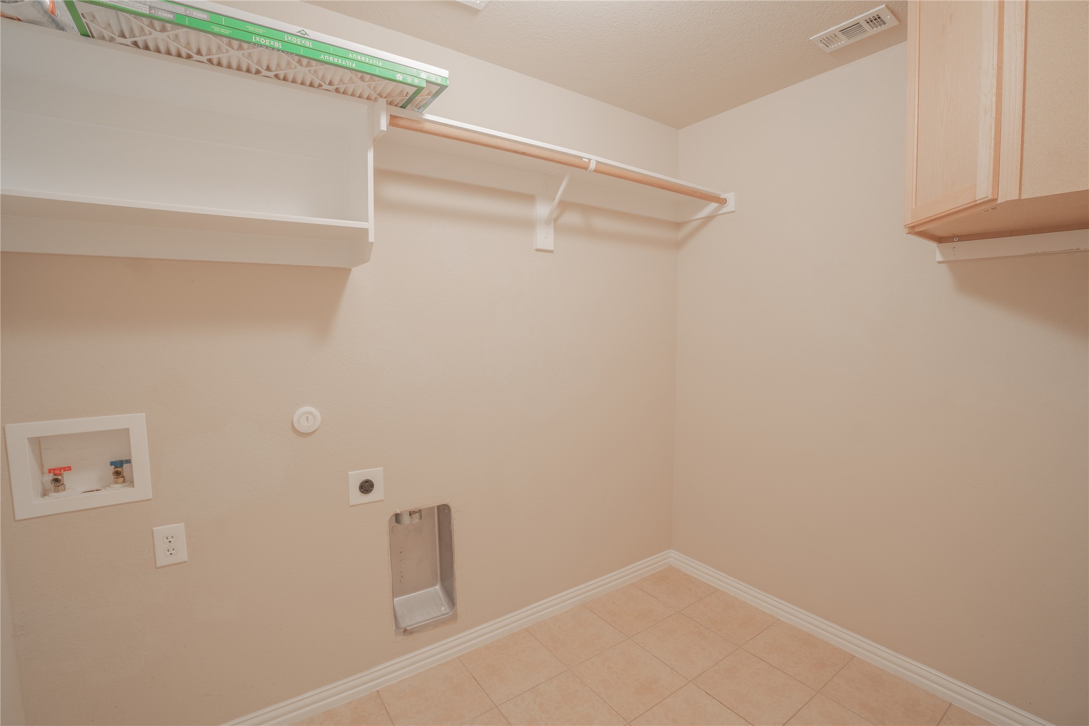 403 Tascate Street Georgetown, TX 78628 - Photo 22 of 26 A well-appointed utility room featuring a practical shelving unit and a convenient hanging rod.