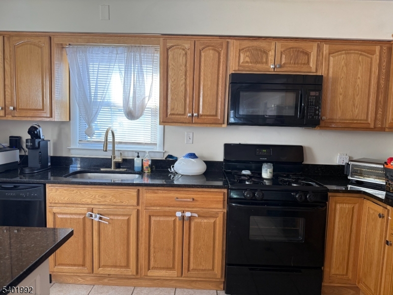 6 Underhill Court, Unit 2 Nutley, NJ 07110 - Photo 3 of 11 a kitchen with granite countertop a stove sink and cabinets