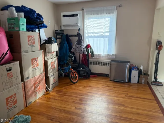 a view of a room with wooden floor and windows