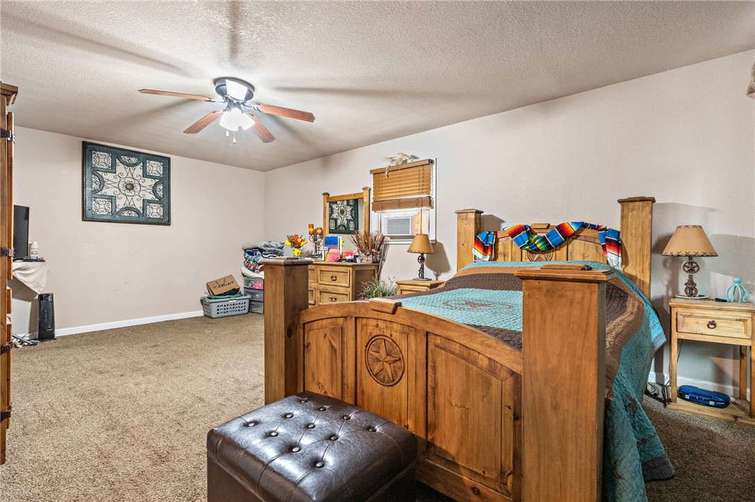 114 Brewster Street Waco, TX 76706 - Photo 10 of 16 a bedroom with furniture and a chandelier fan