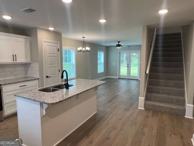 a bathroom with a granite countertop sink