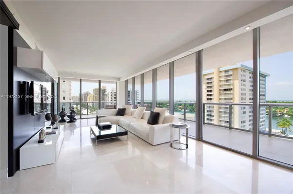 a living room with furniture and large windows