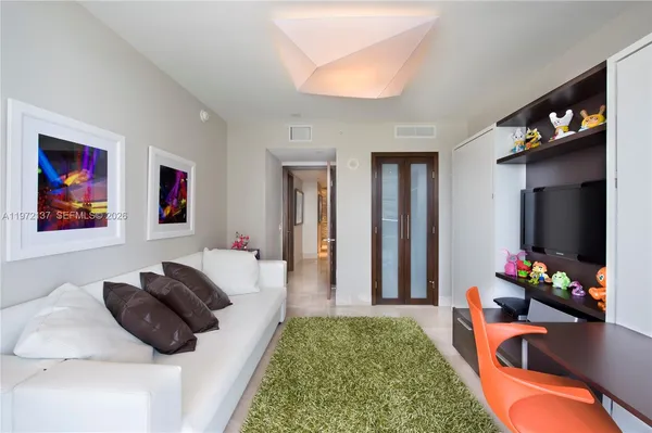 a living room with furniture fireplace and a flat screen tv