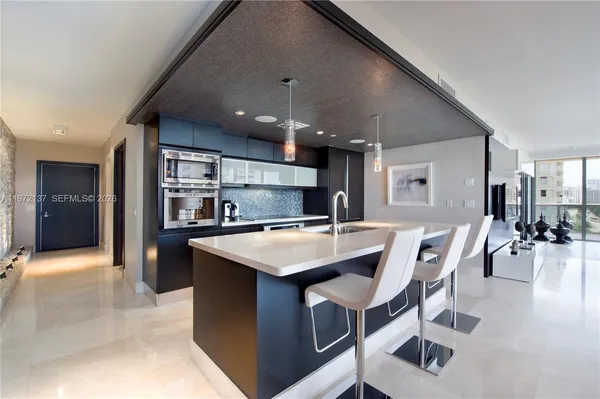 a kitchen with a table chairs and a dining table
