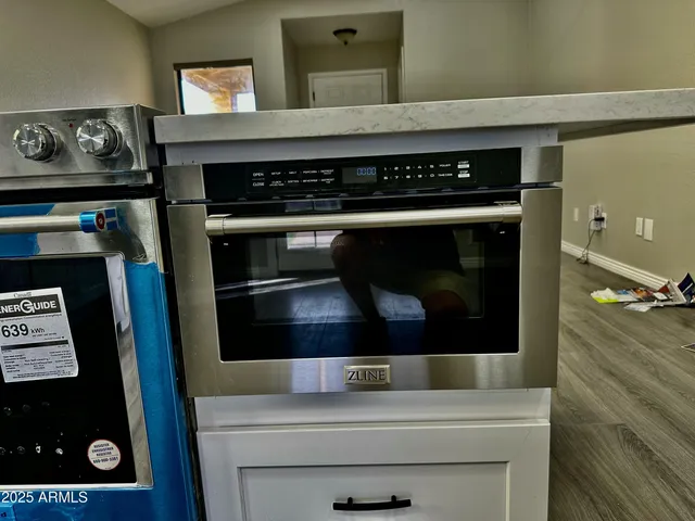 a stove top oven sitting inside of a kitchen