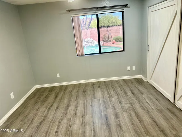 a view of a room with wooden floor and window