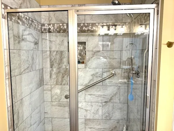 a bathroom with a glass shower door