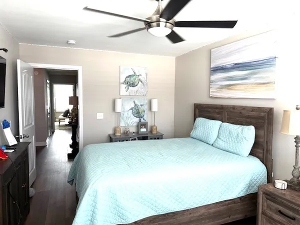 a bedroom with a bed mirror and a window