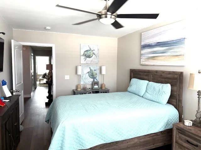 a bedroom with a bed mirror and a window