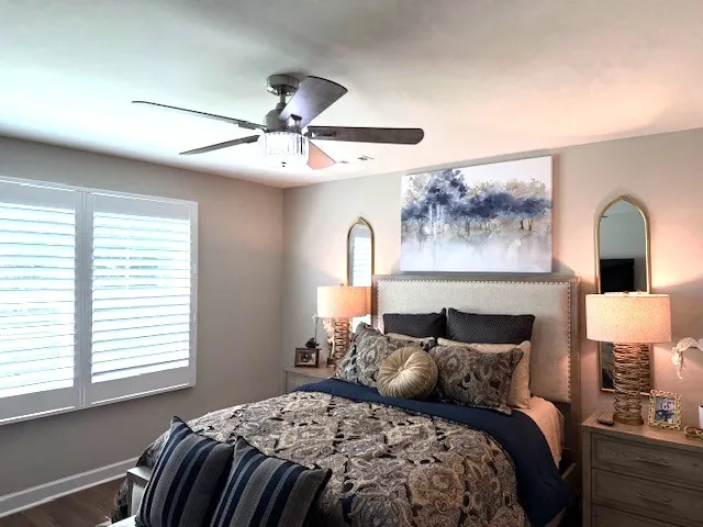 a bedroom with a bed and a lamp