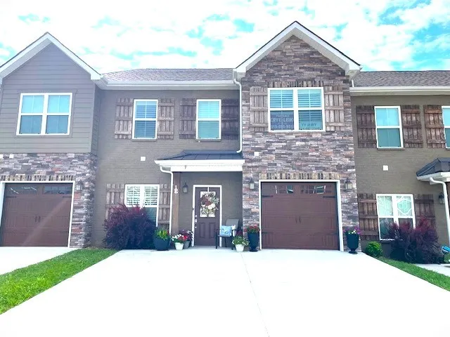 a front view of a house with a yard and garage