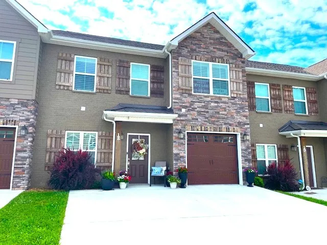 a front view of a house with a yard and garage