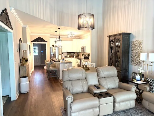 a living room with furniture and wooden floor