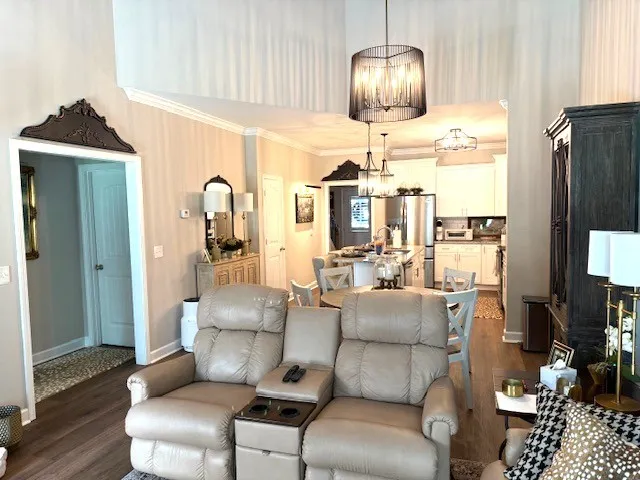 a living room with furniture and a chandelier