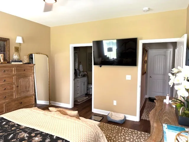 a bedroom with a bed and a television