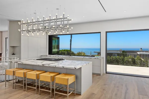 a large kitchen with a table and chairs in it