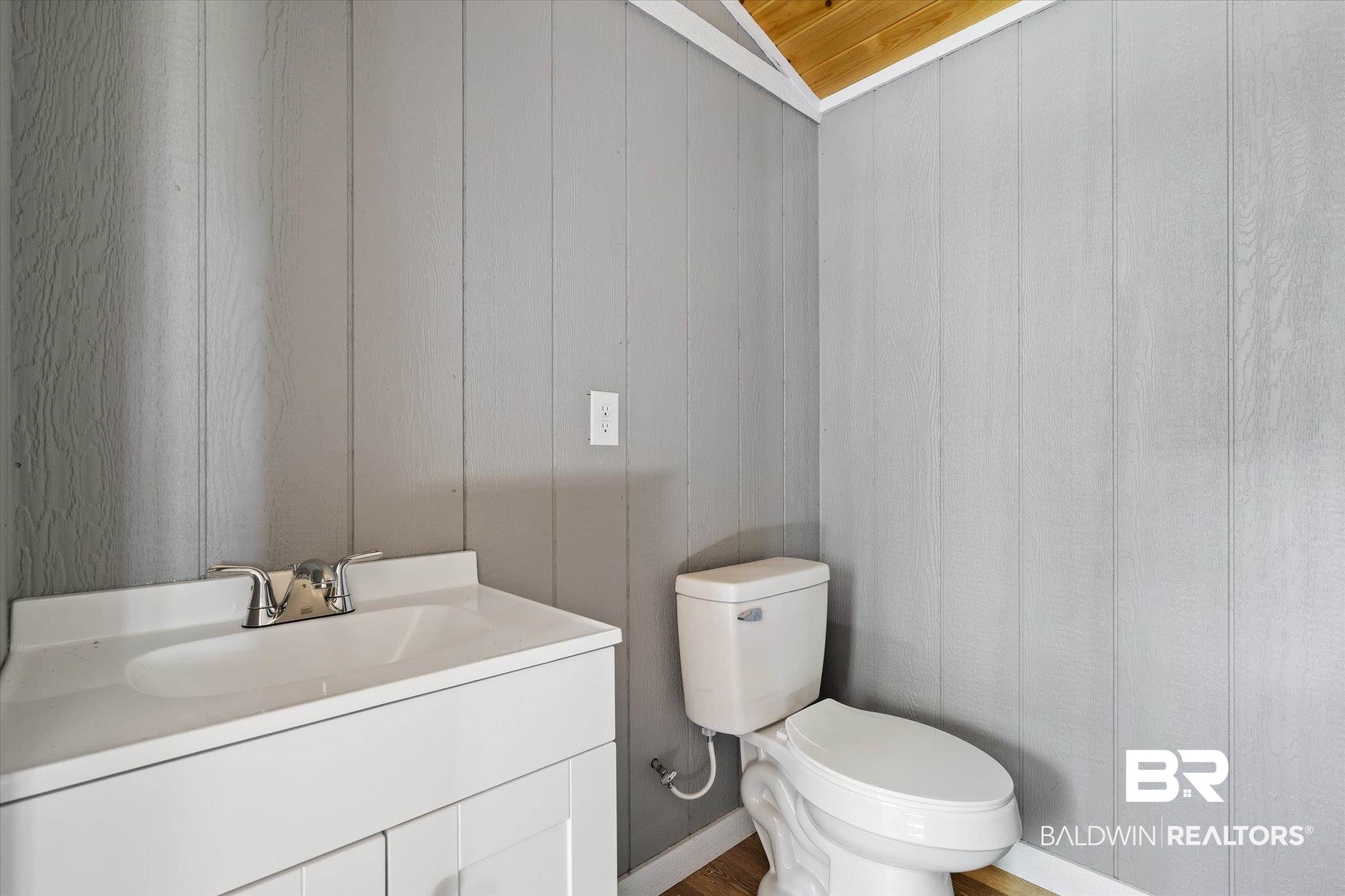 15685 Louis Cooper Road Bay Minette, AL 36507 - Photo 25 of 26 Bathroom featuring vaulted ceiling, toilet, hardwood / wood-style floors, and vanity
