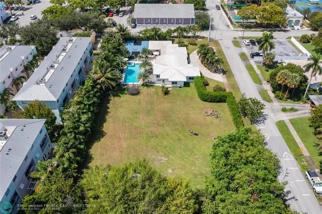 an aerial view of residential houses with outdoor space