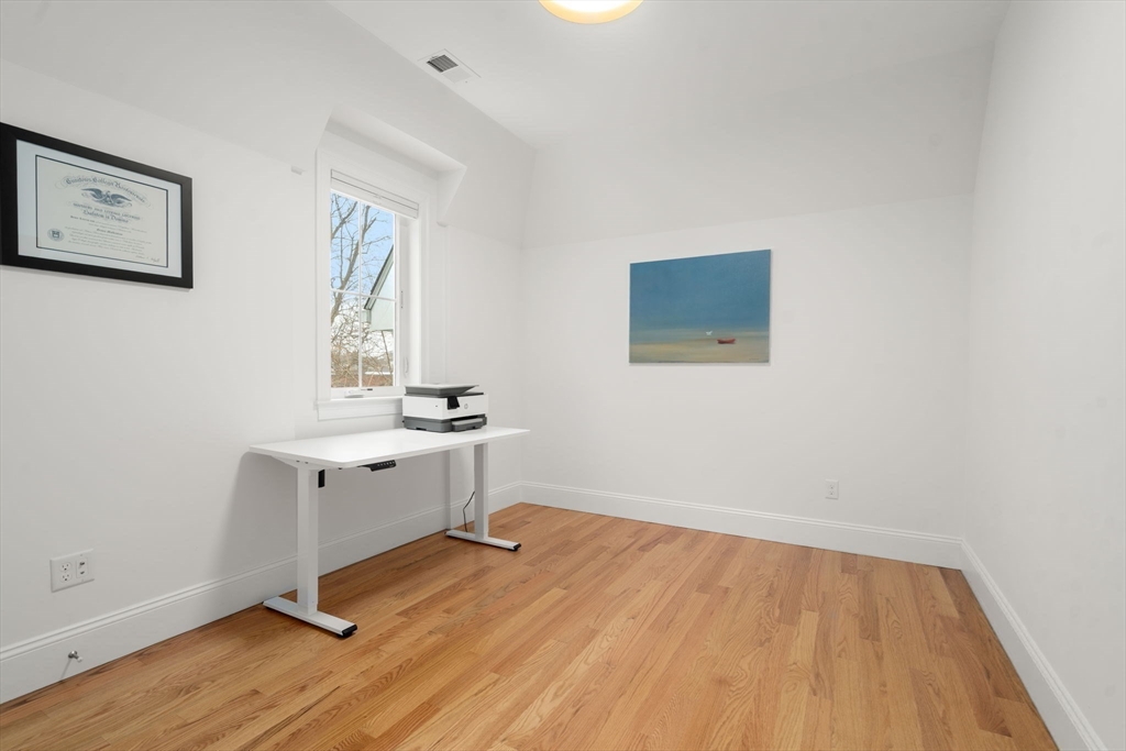 68 Chestnut Street, Unit 6 Newton, MA 02465 - Photo 12 of 22 a room with a desk and wooden floor