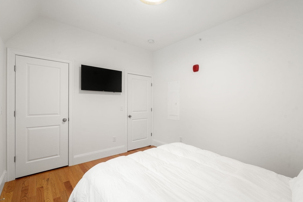 68 Chestnut Street, Unit 6 Newton, MA 02465 - Photo 14 of 22 a bedroom with a bed and a flat screen tv