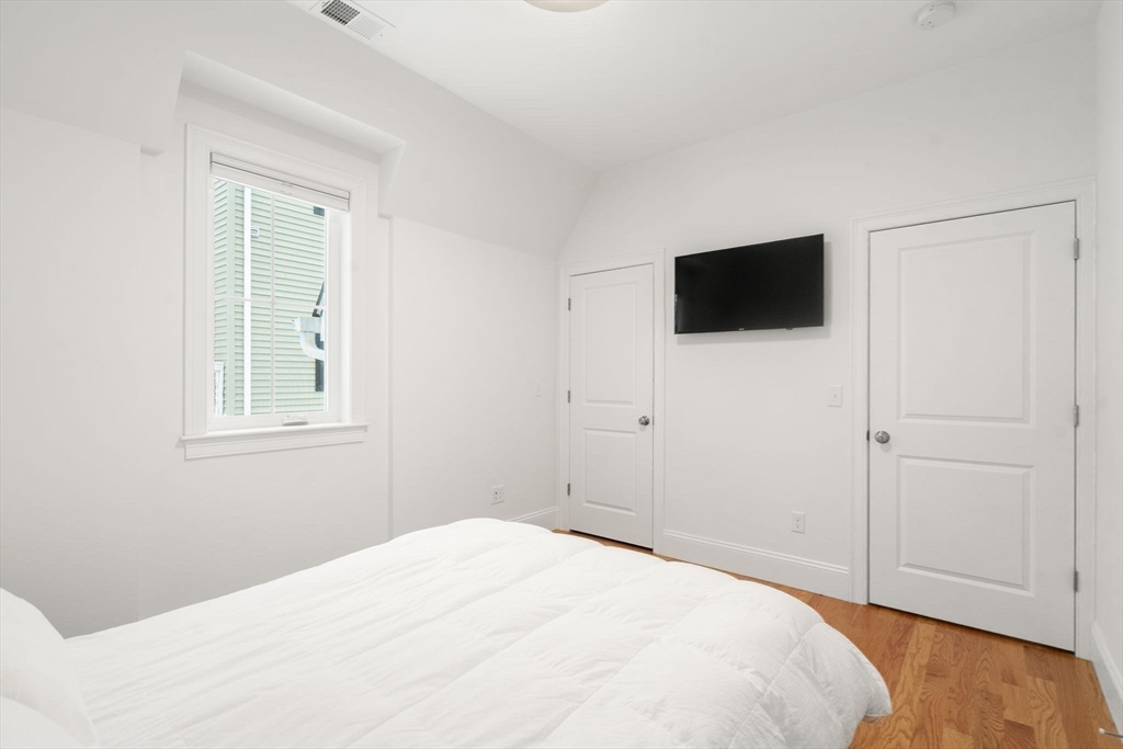 68 Chestnut Street, Unit 6 Newton, MA 02465 - Photo 15 of 22 a bedroom with a bed and a flat screen tv