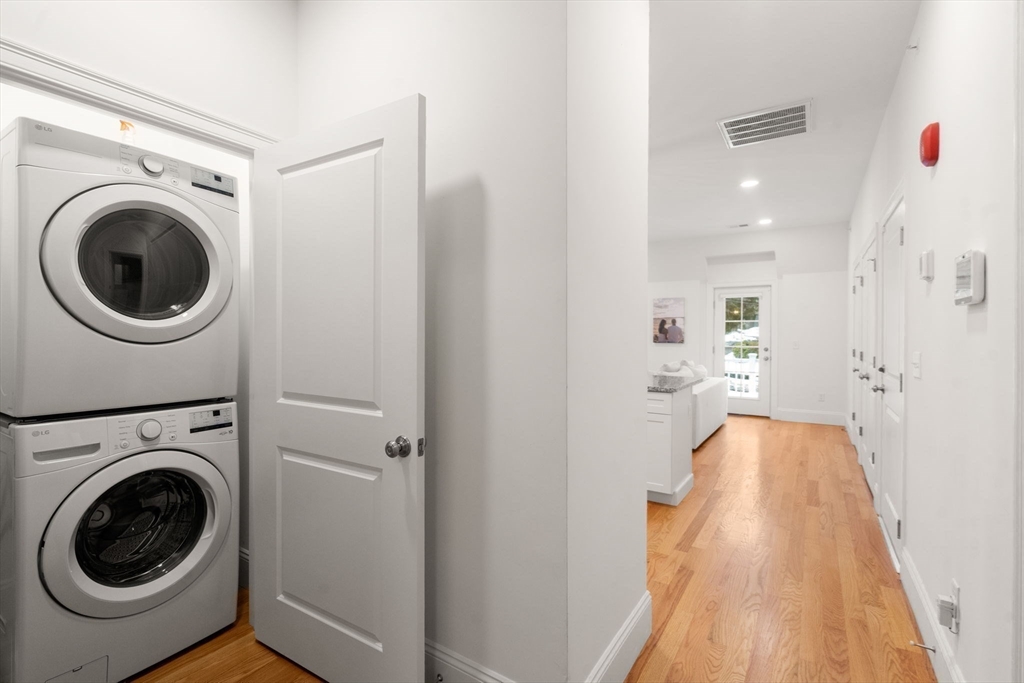 68 Chestnut Street, Unit 6 Newton, MA 02465 - Photo 17 of 22 a view of a hallway with washer and dryer