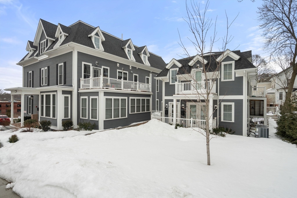68 Chestnut Street, Unit 6 Newton, MA 02465 - Photo 2 of 22 a view of a building with a yard covered in snow