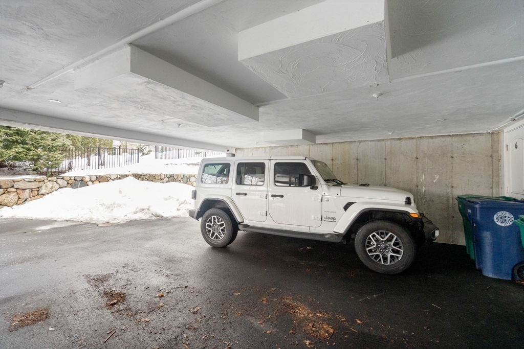68 Chestnut Street, Unit 6 Newton, MA 02465 - Photo 21 of 22 a view of a garage and car parked